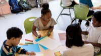 Elementary school students working in small group in classroom