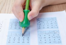 Elementary student writing on a math worksheet